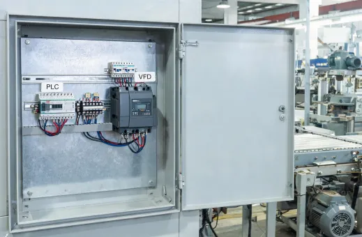 Automation cabinet beside production machinery